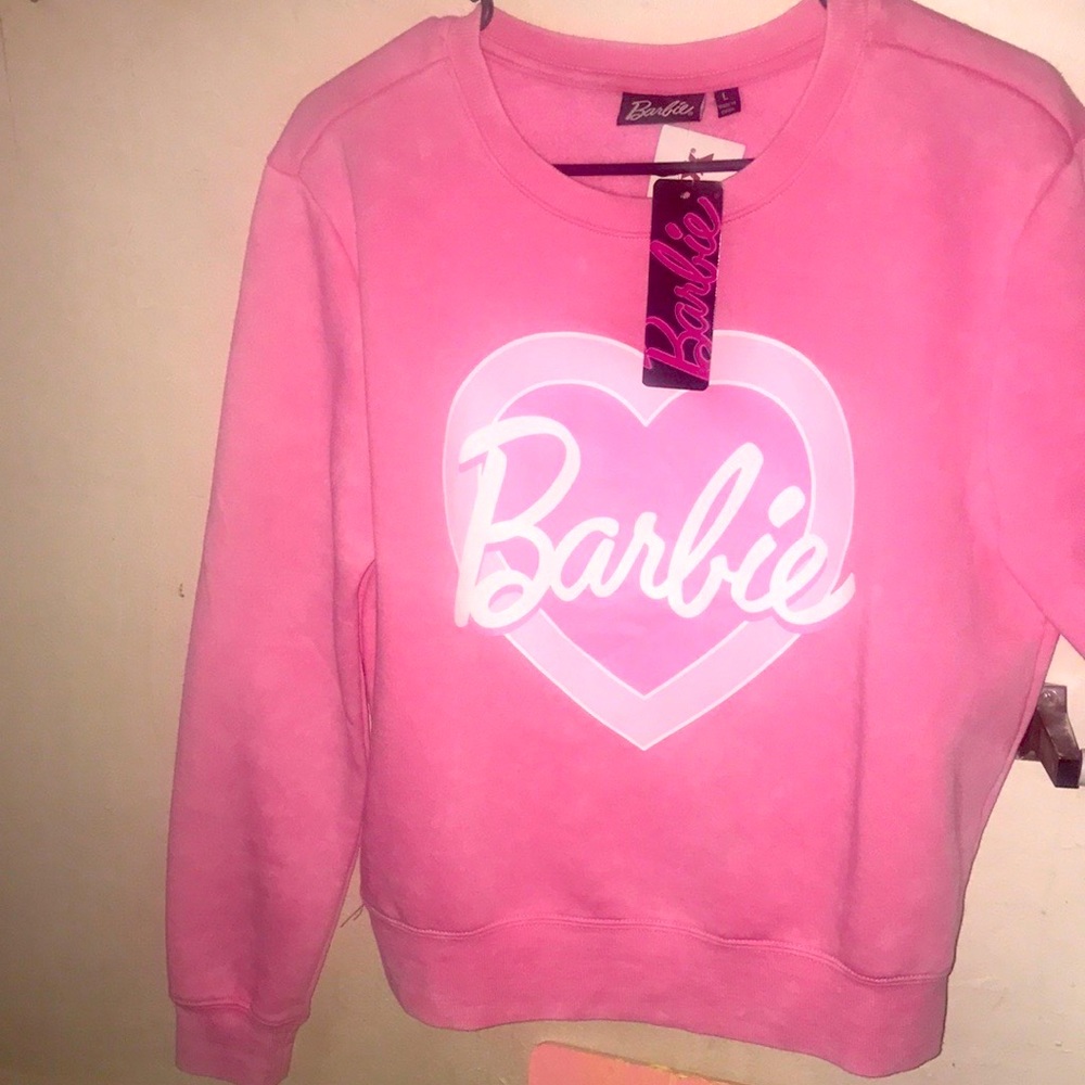 Three separate Barbie outfits one sweater one top one crop to